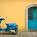 blue scooter motorcycle outside house