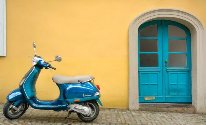 blue scooter motorcycle outside house